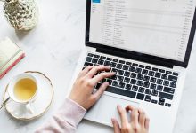 Laptop programming next to a cup of tea